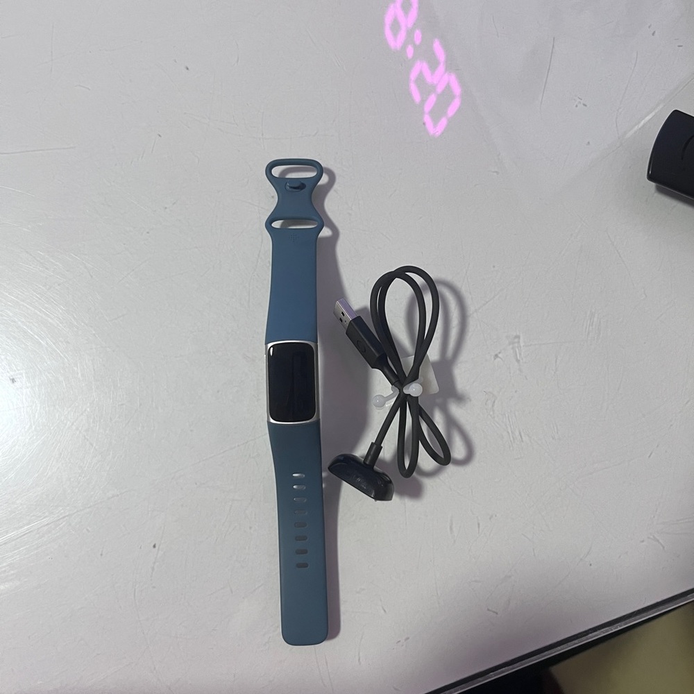Used once. Fitbit Charge 5. Blue.